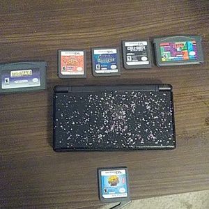 A ds lite with 4 ds games and 2 gameboy advanced